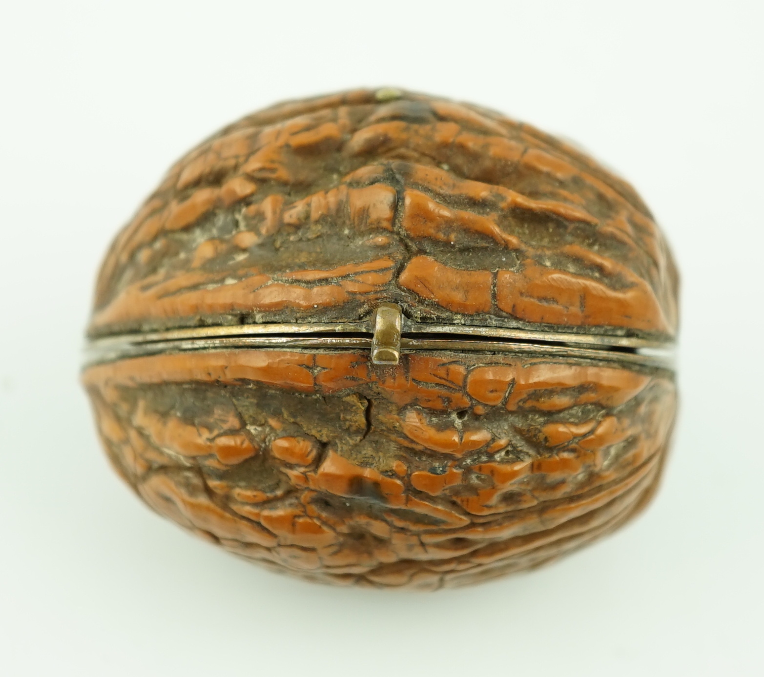 A 19th century French novelty etui case, modelled as a walnut, containing six silver or silver mounted implements